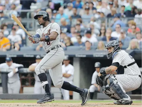  ?? ELSA/GETTY IMAGES ?? Justin Upton of the Detroit Tigers hits an RBI double in the first inning of Wednesday afternoon’s game as Gary Sanchez of the New York Yankees watches at Yankee Stadium in the Bronx. That was all the offence the Tigers needed as they went on to a 2-0...