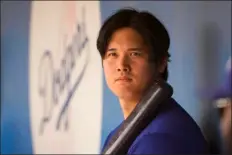  ?? LINDSEY WASSON — THE ASSOCIATED PRESS ?? Los Angeles Dodgers designated hitter Shohei Ohtani holds a bat in the dugout during a spring training baseball game against the San Francisco Giants, Tuesday, March 12, 2024, in Phoenix.