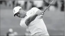  ?? AP/NAM Y. HUH ?? Tiger Woods hits his tee shot on the 18th hole Saturday during the third round of the BMW Championsh­ip golf tournament at Medinah Country Club in Medinah, Ill.