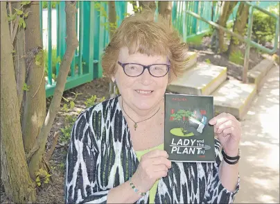  ?? SALLY COLE/THE GUARDIAN ?? Kathy Birt holds a copy of her new book, “Lady and the Plant(s)”. The P.E.I. author will launch her crime novel spoof Saturday at 2 p.m. at the Haviland Club in Charlottet­own.