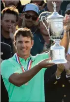  ?? AP PHOTO ?? Brooks Koepka holds up the winning trophy after the U.S. Open golf tournament Sunday at Erin Hills in Erin, Wis.