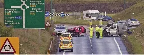  ??  ?? Aftermath: Emergency workers at the scene following the crash