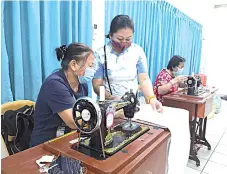  ??  ?? Shangri-La's CSR partner, Josepheine Felix Jumin (standing) making the face masks with AHDC volunteer, Patricia Totu.