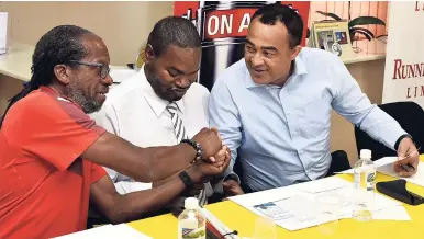  ??  ?? Health Minister Dr Christophe­r Tufton (right) shakes the hand of Director of Running Events Limited Alfred Francis (left) during the media launch of the Everyone’s a Winner 5k and 10k races on Tuesday at the Jamaica Society for the Blind (JSB)...