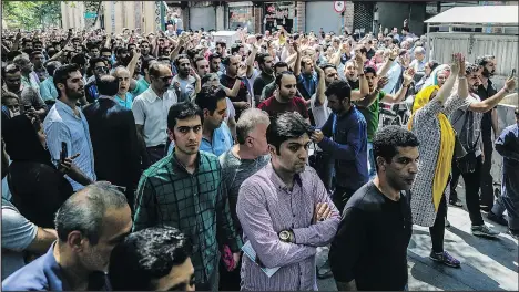  ?? — AP ?? Protesters chant slogans at Tehran’s old grand bazaar in Iran on Monday. People took to the streets again yesterday forcing shops to close in apparent anger over the Islamic Republic’s troubled economy.