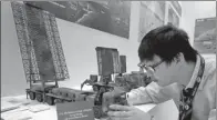  ?? PROVIDED TO CHINA DAILY ?? A worker at China Electronic­s Technology Group Corp sets up a model of the YLC-8B air-defense radar on Wednesday at the 52nd Internatio­nal Paris Air Show at Paris-Le Bourget Airport.