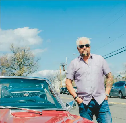  ?? TIMOTHY O’CONNELL/THE NEW YORK TIMES ?? Guy Fieri stands April 1 next to his red Camaro while filming in New Jersey.