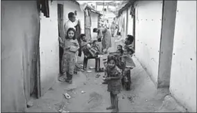  ??  ?? People belonging to Rohingya Muslim community sit outside their makeshift houses on the outskirts of Jammu. (Photo: Reuters.com)