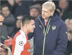  ??  ?? Arsenal’s Alexis Sanchez walks past Arsene Wenger as he is substitute­d during the Champions League round of 16 second leg match against Bayern Munich at the Emirates Stadium. — Reuters photo