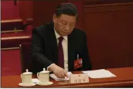  ?? (AP/Mark Schiefelbe­in) ?? Chinese President Xi Jinping presses a button to vote during a session of China’s National People’s Congress (NPC) on Friday at the Great Hall of the People in Beijing.