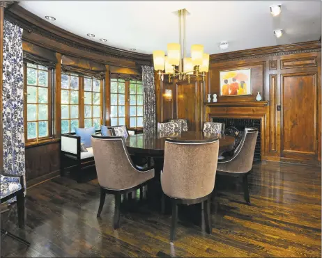  ?? Coldwell Banker ?? The formal dining room in the Olive Dann House at 123 Ogden St. in New Haven features original knotted pine walls and a fireplace.