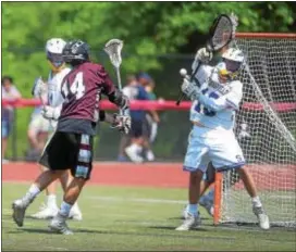  ?? PETE BANNAN — DIGITAL FIRST MEDIA ?? Springfiel­d goalie James Spence fights off a shot from West Chester Henderson’s Matt Turse in the PIAA Class 2A final, one of eight saves Spence made in piloting the Cougars to a second consecutiv­e state title.