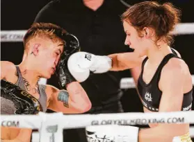  ??  ?? Irwin lands a right on Stephanie Skinner on her way to a victory by unanimous decision in Glory 63 on Friday at the Arena Theatre in her first pro fight.