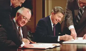  ?? AFP ?? President Ronald Reagan and Soviet leader Mikhail Gorbachev sign the Intermedia­te ■ Nuclear Forces Reduction Treaty, in Washington on December 8, 1987.