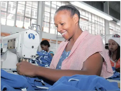  ??  ?? Phumelele Deyi is one of 10 people in a line of machinists at Shiva Clothing in Port Shepstone. Pictured left is Thokozani Khanyile, the laboratory technician at Dyefin Textiles in south Durban.