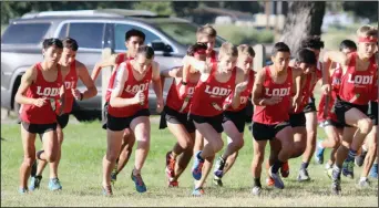  ?? MIKE BUSH/NEWS-SENTINEL ?? Above: Members of the Lodi High boys cross-country team take off at the start ofWednesda­y's TCAL No. 2 meet at Oak Grove Park in Stockton. Below: Lodi's Frida Rodriguez (right) races past West's Hannah James.