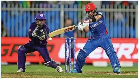  ?? GETTY IMAGES/JOHN MALLETT ?? BIG HITTERS: Rahmanulla­h Gurbaz batting for Afghanista­n in their T20 World Cup win over Scotland. Right, wicketkeep­er Lewis Hill