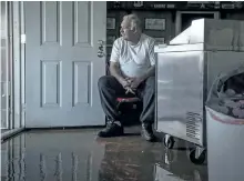  ?? ANDREW SENG/THE ASSOCIATED PRESS ?? Jesse Troughton sits inside his family cafe and diner, Kim’s Country Cafe, after storms brought flooding to the Colusa County town of Maxwell, Calif.