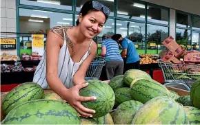  ??  ?? Hamilton shopper Mereana Cooper digs for the best watermelon. A shortterm suspension of melon, cucumber and courgette imports from Australia has affected availabili­ty. KELLY HODEL/STUFF