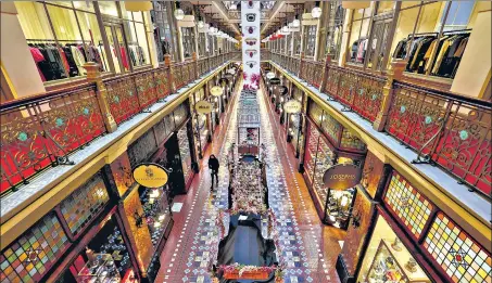  ?? BLOOMBERG ?? A pedestrian walks through the empty Queen Victoria Building during a lockdown imposed due to a fresh spike in coronaviru­s cases, in Sydney on Tuesday.