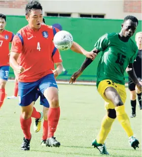  ??  ?? In this file photo from July 27, 2015, Jamaica’s Cavar McKenzie (right) and Kee Nam Park of South Korea battle for the ball during a match at the Special Olympics World Games in Los Angeles.
