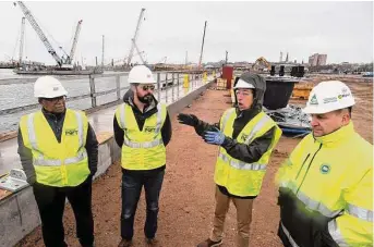  ?? Ned Gerard / Hearst Connecticu­t Media ?? David Kooris, third from left, chairman of the Connecticu­t Port Authority, speaks during a tour of the New London State Pier upgrade project in New London on Jan. 12. When complete, the pier facility will serve as a heavy-lift cargo port for a variety of uses, including as a hub for the offshore wind industry. Kooris is seen here with port authority Executive Director Ulysses Hammond, Business Projects and Special Projects Manager Andrew Lavigne and Program Manager Joseph Salvatore.