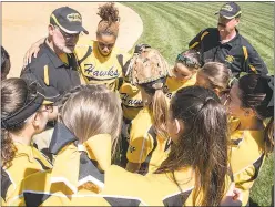  ?? PHOTOS COURTESY OF COLLEGE OF SOUTHERN MARYLAND ?? CSM head softball coach Jim Cleary, left, and assistant coach Bill Hitte, gather the team together before the start of a doublehead­er against Cecil Community College on April 20.