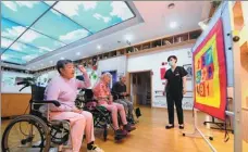  ?? WANG XIAO / XINHUA ?? A caregiver (right) at a senior care center in Shijiazhua­ng, Hebei province, encourages some elderly residents to play indoor games on June 2.