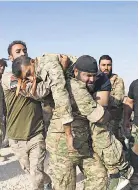  ?? NAZEER AL- KHATIB AFP VIA GETTY IMAGES ?? Turkish- backed Syrian fighters evacuate a comrade near Ras al- Ain.