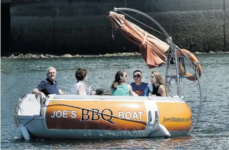  ?? NICK PROCAYLO/PNG ?? Joe’s BBQ Boat Rentals allows a group of up to eight to grill up some grub while plying the waters of False Creek.