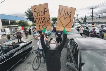  ?? Jason Armond Los Angeles Times ?? RELATIVES OF Andres Guardado rally with civil rights activists in Gardena last month. Guardado, 18, was shot June 18. The two deputies involved have been identified; both work out of the Compton station.