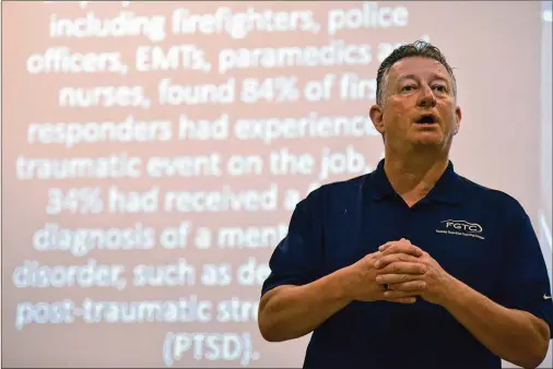  ?? HYOSUB SHIN / HYOSUB.SHIN@AJC.COM ?? In front of prospectiv­e medics at Faithful Guardian Training Center in Temple west of Atlanta, Thomas Woodruff, a former paramedic and founder of the center, discusses ways Wednesday to prevent PTSD and burnout. Stress on ambulance crews is creating mental health concerns.