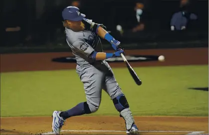  ?? ERIC GAY — THE ASSOCIATED PRESS ?? The Dodgers’ Justin Turner hits a home run against the Tampa Bay Rays during the first inning in Game 4 of the World Series on Saturday in Arlington, Texas. His 12th home run pushed him one past Duke Snyder for the franchise lead in postseason homers.