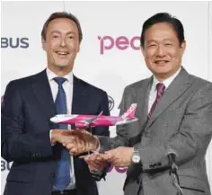  ??  ?? TOKYO: Airbus ECO Fabrice Bregier (left) shakes hands with CEO of Japan’s low cost carrier Peach Aviation Shinichi Inoue during a joint press conference in Tokyo yesterday.