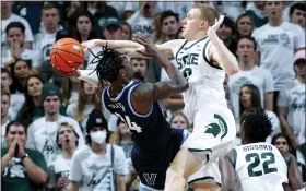  ?? AL GOLDIS — THE ASSOCIATED PRESS ?? Michigan State’s Joey Hauser, right, blocks the shot of Villanova’s Brandon Slater during Friday’s victory. The Spartans are in the AP Top 25for the first this season at No. 12.