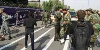 ?? (Tasnim News Agency/Reuters) ?? SECURITY FORCES react after an Iranian military parade was attacked by gunmen yesterday in Ahvaz, Iran.