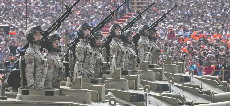  ?? Kevin Frayer / Gett y Images files ?? Chinese soldiers ride atop tanks in a parade to celebrate the 70th Anniversar­y of the founding of the People’s Republic of China in 1949, at Tiananmen Square last October.