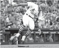  ?? Jeff Roberson/Associated Press ?? ■ St. Louis Cardinals’ Kolten Wong scores during the eighth inning of a baseball game against the Cincinnati Reds on Sunday in St. Louis.