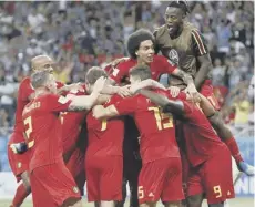  ??  ?? 0 Jubilant Belgian players pile on Nacer Chadli after his goal.