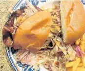  ?? AMY DREW THOMPSON/ORLANDO SENTINEL ?? Oh, that pulled chicken ... Topped with slaw and served alongside seasoned fries, it features light and dark meats.