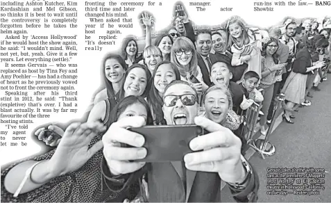  ??  ?? Gervais takes a‘selfie’ with some fans at the premiere of ‘Muppets Most Wanted’ at El Capitan theatre in Hollywood, California, on Tuesday. — Reuters photo