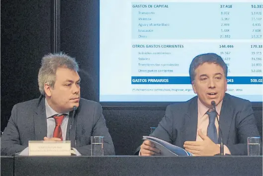  ?? NESTOR GARCIA ?? Reformador­es. Viceminist­ro Galiani y ministro Dujovne, en la presentaci­ón de un informe sobre las cuentas fiscales.