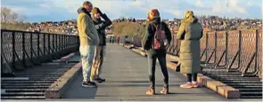  ?? ?? Walkers stop for a chat on the viaduct.