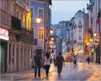  ?? THE ASSOCIATED PRESS ?? Coimbra’s main pedestrian street divides the lower part of the old town (Baixa) from the upper (Alta). Be sure to visit the market and try the salt cod. To find it, just follow your nose.