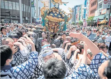  ?? ?? Participan­ts carry a portable shrine outside Sensoji Temple in the Asakusa district of Tokyo during the annual Sanja Matsuri festival in May 2018.