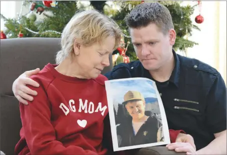  ?? MARK BRETT/ Special to the Okanagan Newspaper Group ?? Tyler Lemire with mom Katherine and a photo of the brother and son who died of an overdose in March of this year. Tyler is currently a client of Discovery House where he is beating the same addiction that killed his brother.