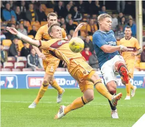  ??  ?? Motherwell’s Stephen Hammell tackles Rangers’ Martyn Waghorn