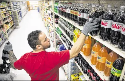  ?? MATT ROURKE / AP ?? Beverage makers in Philadelph­ia say the new tax measure is hurting sales so much they need to cut jobs, while city officials say the moves are a ploy to get the tax struck down.