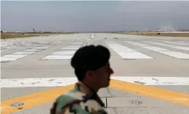  ?? Photograph: Mohammad Ismail/Reuters ?? An Afghan soldier by the runway at the huge Bagram airbase following the departure of US troops.