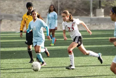  ?? Haley Sawyer/The Signal (See additional photos on signalscv.com) ?? SCCS girls soccer’s Ellyanna Edwards (23) rushes after the ball in a CIF-Southern Section Division 7 semifinal game against Azusa at College of the Canyons on Tuesday as the Aztecs’ Adamaris Arteaga (10) runs alongside her.